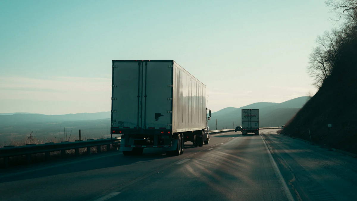 Two semi-trucks hauling trailers along a highway through wooded hills
